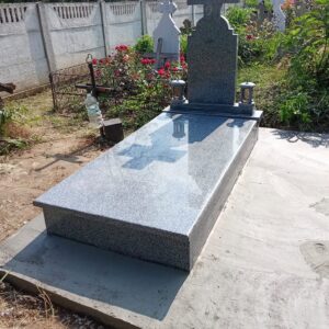 Monument funerar din granit lucios cu cruce si cadru mormant.